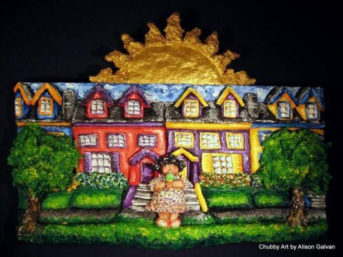 Textured Sculptamold relief sculpture of colorful houses, green trees, and a golden sun against a black background.